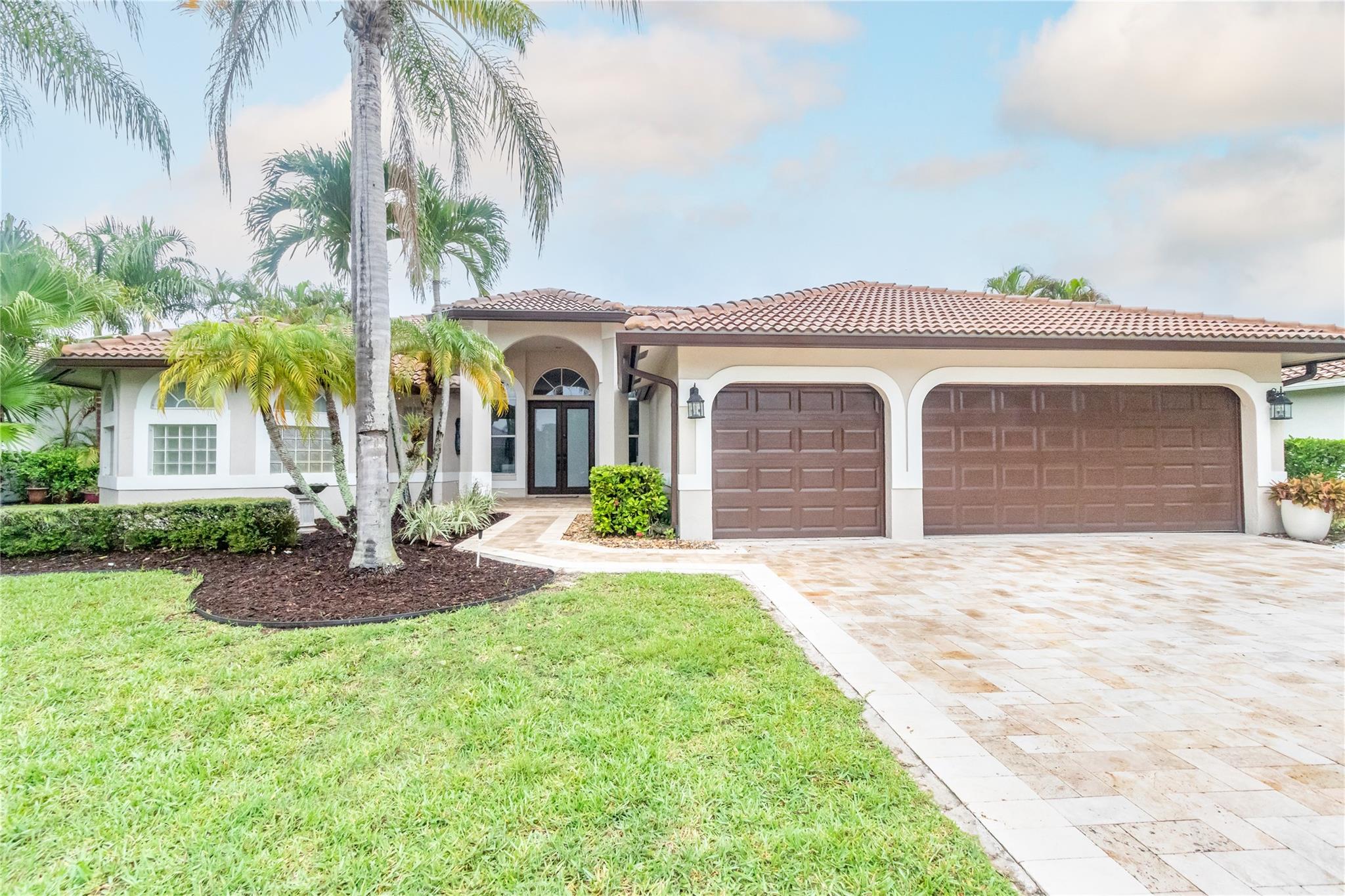 Renovated 6BR/4BA pool home in sought-after Kensington Glen. Over 3,000 SF on .25 acre+ lot. Move-in ready w/ marble floors, open layout & modern kitchen perfect for entertaining. Primary suite has 2 walk-in closets, spa bath w/ 2-person jacuzzi, waterfall shower & private WC. Two add’l BRs have ensuite baths & walk-ins ideal for guests or multi-gen living. Freshly painted in/out. Resort-style saltwater pool w/ waterfall, travertine deck, mature palms. 2019 roof w/ seamless gutters & 2 Rheem 3T A/Cs in 2020. Zoned for top-rated schools incl. Marjory Stoneman Douglas High. Low HOA & lower taxes than Parkland.