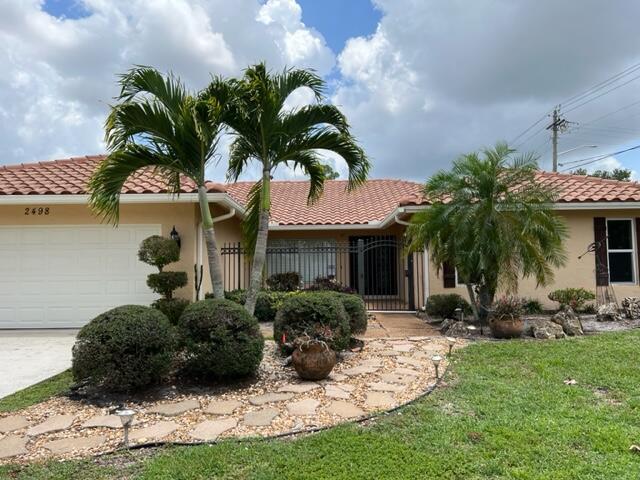 Experience resort-inspired living at its finest in this vibrant corner-lot retreat, where privacy is paramount behind lush fencing and tropical landscaping. Unwind by your sparkling pool, refresh in the outdoor shower, or entertain in expansive open-concept living and dining spaces bathed in natural light and adorned with Saturnia marble floors. The kitchen with stainless steel appliances, custom cabinetry, granite counters, and a dedicated wine cooler--perfect for hosting family and friends.French doors reveal a screened-in patio ideal for alfresco dining, while bedrooms invite relaxation with generous space; the master suite impresses with dual walk-in closets and elegant touches throughout. Complete with hurricane impact windows,,