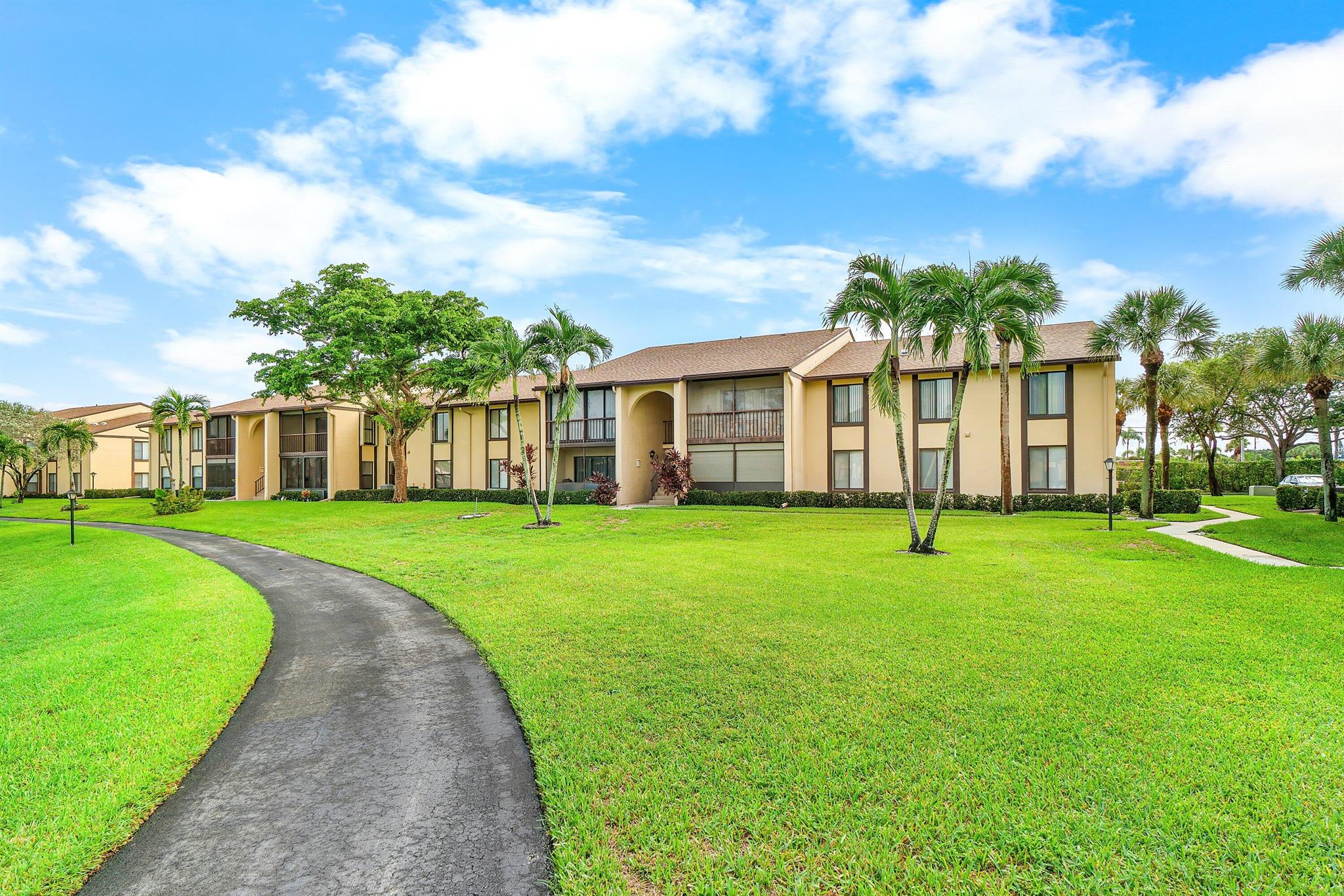 Charming 2-Bedroom, 2-Bath END UNIT in the active, over 55 community of Pine Ridge IV. Light and bright condo with tons of windows and natural light! Accordian shutters for easy storm prep! Enjoy the breezy, tropical Florida lifestyle on your screened- in porch w/ glistening lake view - premium lake front lot. AC 2023. Large, open living areas make entertaining easy. Bedrooms are a generous size. Storage is no issue with a huge walk-in closet & large laundry room w/ built-in cabinetry. Pine Ridge IV is ideally located in the heart of Greenacres. Two tranquil lakes grace the community, one of which is surrounded by a paved walking path. Amenities include a heated pool, hot tub, tennis/pickleball courts, shuffleboard and bocce courts. Planned social calendar for lots of FUN!