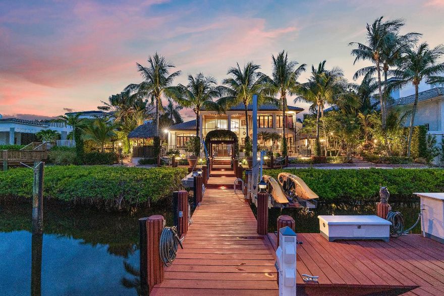 This Waterfront Estate is perfect for the Buyer that wants it all!  Located on a private island street with waterfrontage that can accommodate a large vessel.  Easy access to the Intracoastal and it is close to all the 5 star amenities that Admirals Cove has to offer.   The custom built, Tuscan inspired home, is over 5,800 square feet with a perfect blend of formal and casual living.   Lush landscaping, custom wood work, 5 bedrooms, one of which is a private guest apartment, screened in patio, dock for 2 boats with a 12,000 lb. lift and swing lift for jet skis or kayaks, 60 k generator, air conditioned 4 car plus golf cart garage and so much more!  This home is classic sophistication and timeless elegance at its best.