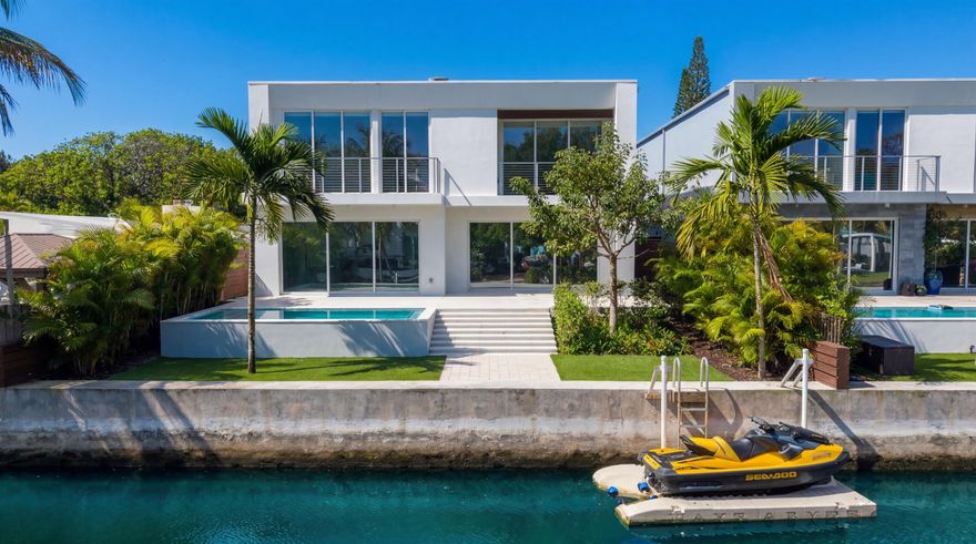 New Museum Modern Waterfront Estate with Private Pool recently completed by Federico Zapata at ProjectLand. This 4 Bedroom plus den, 4 Full Bath, all en-suite, is sited on 50' of waterfront with only one fixed bridge offering quick ocean access with immediate access from the Tarpon River. This 2 story modern boasts high end designer finishes, a 2-bay garage, and a huge walk-in fitted master closet. Impressive chefs kitchen with professional grade appliances and open island design with seating. Large format porcelain tile downstairs and white-oak wide wood plank floors upstairs. Floor to ceiling pocketing sliding glass doors lead to quiet and bright waterside backyard with a private sun-splashed pool and low maintenance tropical landscaping and outdoor lighting. Minutes to FLL Int. Airport