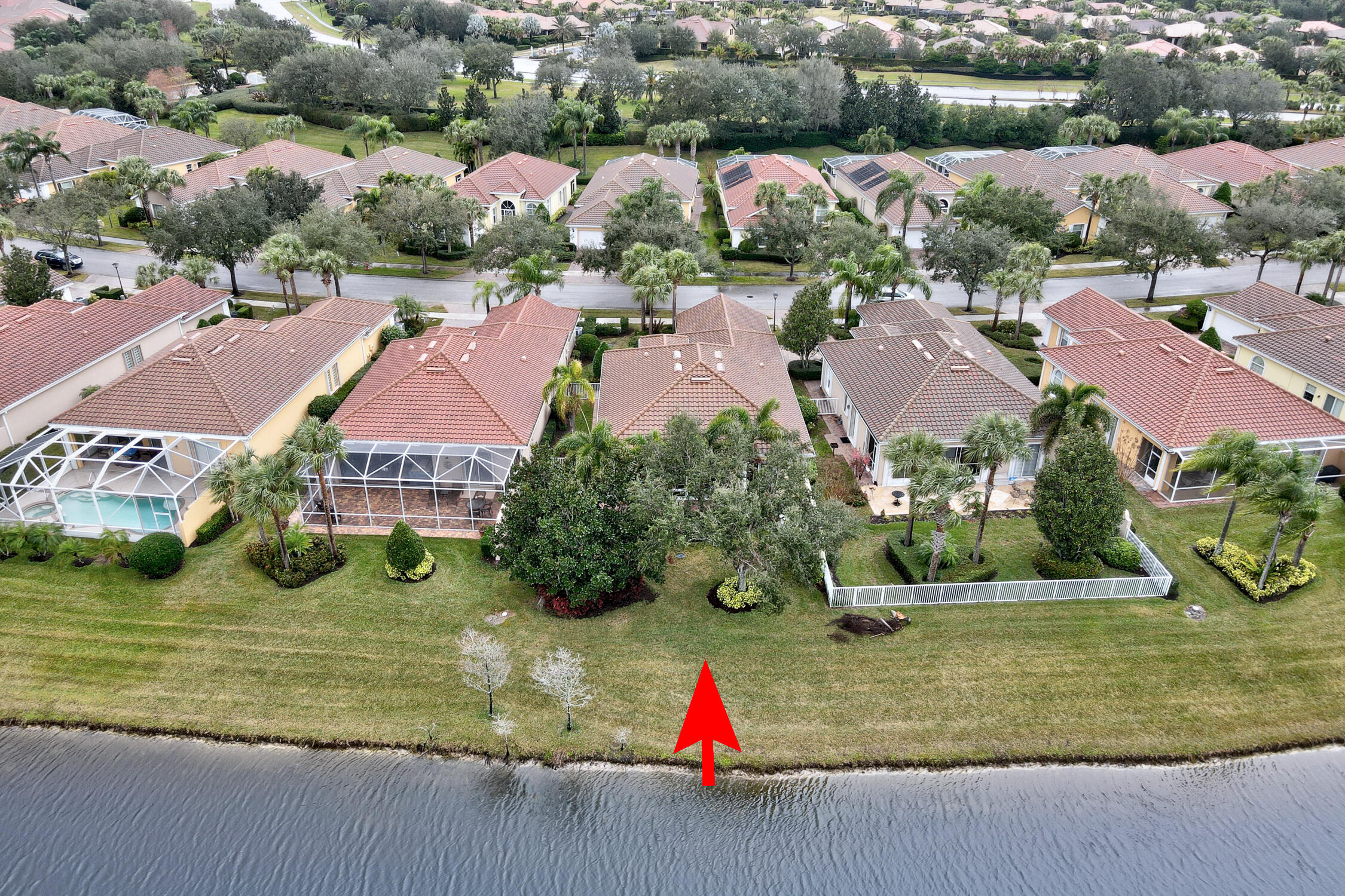 The Isles at Waterway Village; DiVosta built Oakmont model 3BR/3BA+den on the lake w/ southeast exposure. Home features: whole house generator w/ buried propane tank; enclosed porch w/ impact windows; primary bedroom w/ impact slider; accordion shutters everywhere else. Lovely built-ins; 12' ceilings w/ 8' doors; great room concept + separate bonus room/office; the kitchen has granite & stainless steel appliances; even a nice, small fenced in area for Fido! Plus you can move right in: fresh paint & new LVP flooring to accompany the existing tile. Gated; community pool & amenities.