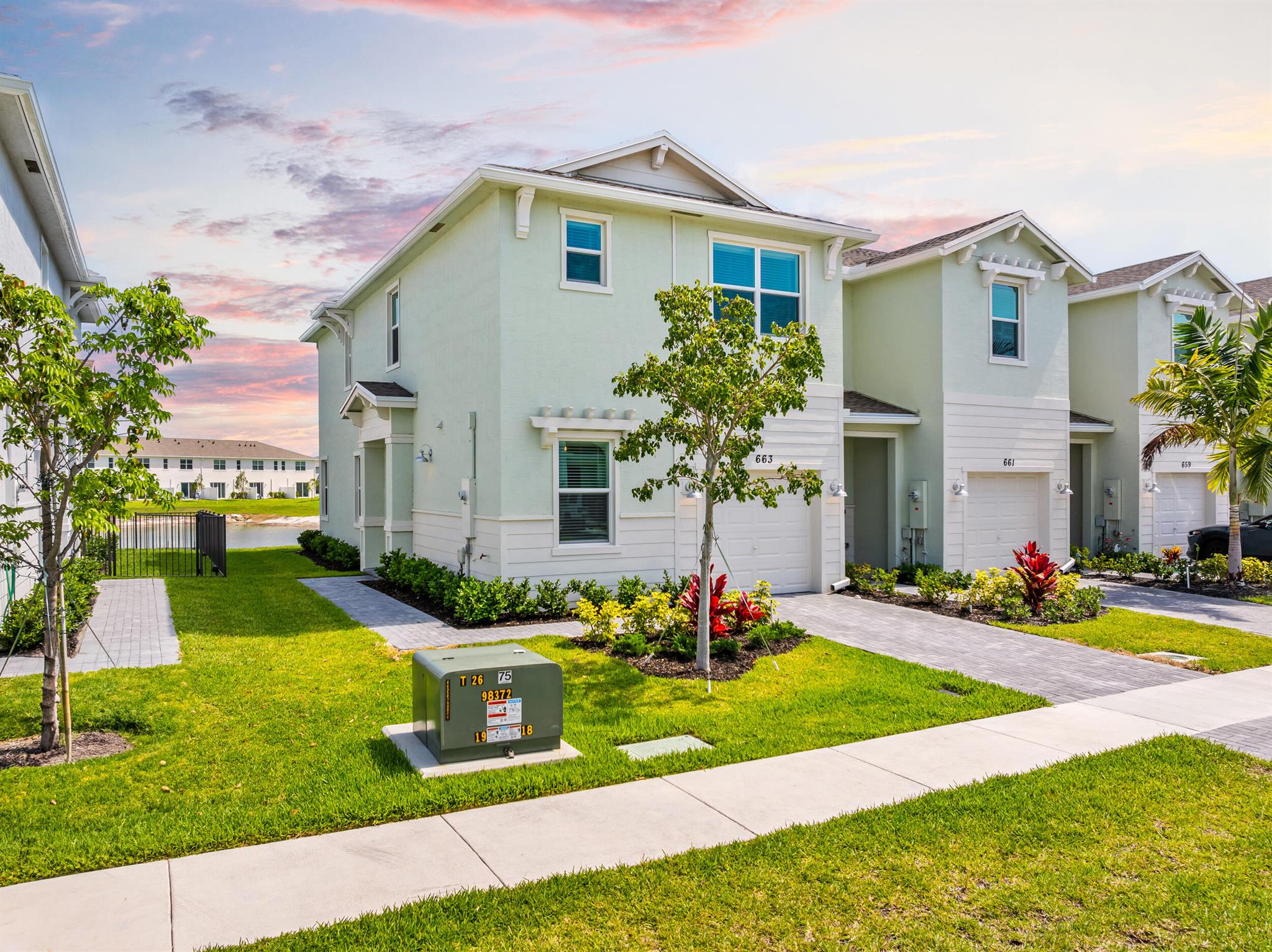 Step into style, comfort, and peace of mind with this nearly-new 3-bedroom, 2.5-bath Lennar townhome in the gated community of Veranda Landing. Built in 2024, this 1,821 sq ft residence offers open-concept living with a sleek modern kitchen, stainless steel appliances, quartz countertops, and a spacious living/dining area that opens to a private patio with tranquil lake views.The seller has added thoughtful upgrades throughout, including custom blinds, elegant curtains with matching rods and finials, dimmer lighting, ceiling fans, stylish new faucets, a dining room chandelier, and an epoxy-finished garage floor for a clean, polished touch.