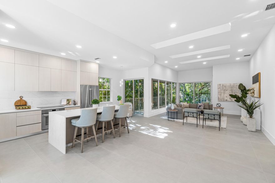 This breathtaking, fully renovated condo presents an expansive floor plan embellished with soaring ceiling heights. Upon entering, you have the option to take your own private brand-new elevator or stairs, where you will be greeted with your open layout. The newly redesigned kitchen offers contemporary modern elements and Thermador appliances, including a stylish kitchen island as its centerpiece, adding both functionality and style to the space. Just across from the kitchen is the elegant dining room, creating a seamless flow for entertaining and family gatherings. Included in this open layout, you'll find the spacious living room, that opens up to a screened wrap-around porch, offering stunning views of the serene lake and tropical palm trees. This tranquil setting provides the perfect   backdrop for relaxation and enjoying the beauty of nature. The primary bedroom is thoughtfully separated from the other bedrooms, offering beautiful views of the lake. It includes dual closets and an en-suite bathroom with dual sinks and a separate oversized shower, providing a luxurious and private retreat within this condo. The second en-suite bedroom is equally impressive, with abundant natural light. The third en-suite bedroom, which can also serve as a spacious den or office, features a plethora of natural light through the sliding glass doors (with electric privacy blinds), making it a versatile and functional area. An impressive powder bathroom with sconce lighting is an added bonus in addition to the brand-new impact glass windows and doors throughout this charming condo. Located in the Catalina section of the Polo Club, a satellite pool is located just down the street in addition to the amazing country club amenities, The Polo Club offers two championship 18-hole golf courses, an internationally awarded tennis/pickleball center, and an 145,000 SF Clubhouse with multiple restaurants, bars, gym/spa, aquatics center, and activities. Mandatory Membership is required.