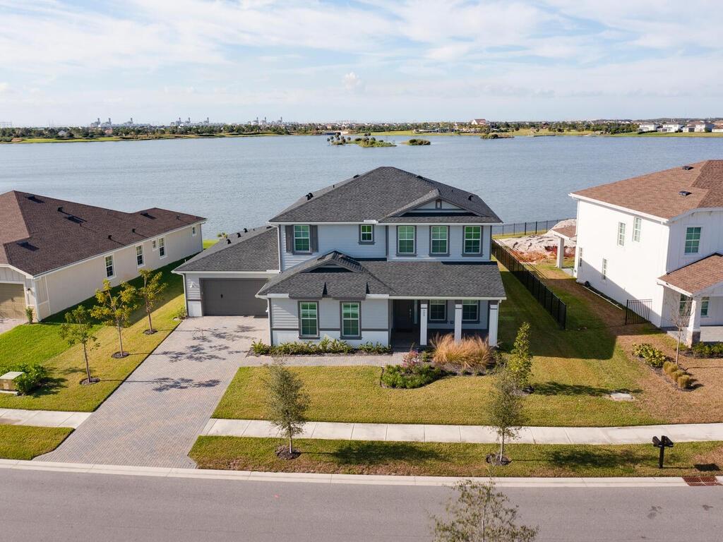 5-bedroom, 4.5-bathroom lakefront home, ideally situated on a private, serene lot in the heart of Arden. With a spacious layout that includes a loft and a separate office/den, this home offers both luxury and versatility for today’s lifestyle. Enjoy breathtaking lake views and a generous backyard with plenty of space to add your dream pool. Outdoor living is made even better with gas cooking and a stub for a summer kitchen—perfect for entertaining! The primary suite is conveniently located on the first floor, featuring a luxury bathroom with dual vanities and a freestanding soaking tub for ultimate relaxation. Enjoy world-class amenities and top-rated schools, with a brand-new school opening nearby!