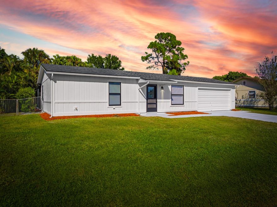 Come see this 3/2/2 beautifully renovated screen enclosure pool home in an outstanding location! Home is situated in a quiet and quaint neighborhood - just minutes away from the Turnpike, I-95 and Tradition. This house comes with a brand new 2025 roof - just replaced, brand new white shaker kitchen cabinets, new quartz countertops and backsplash, newer stainless steel appliances, all new water fixtures, switches/outlets, ceiling fans/lighting fixtures and much more...! It also comes with brand new vanities, gorgeous tile in the bathrooms, brand new luxury vinyl planks and elegant baseboards throughout the whole house. It features an accent wall with a gorgeous interior WPC wall panel to decorate some of the living spaces in the house.