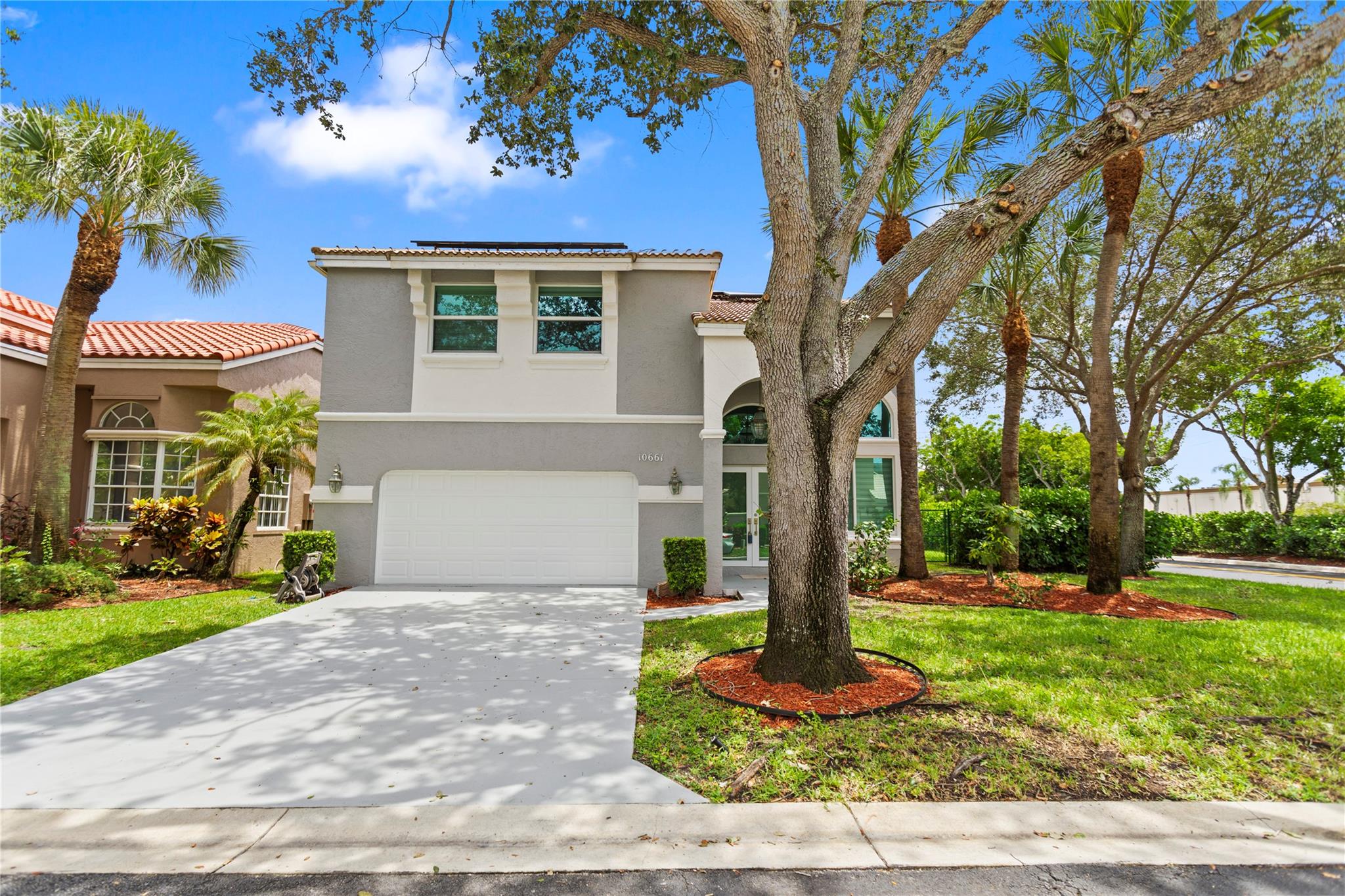 Welcome to this stunning home with soaring 20-foot ceilings that create a grand and open feel from the moment you walk in. 4-bedrooms, 2 full bathrooms are upstairs and a convenient half bath on the main floor. Freshly painted interior/exterior. The oversized primary bedroom offers ample space. The newly renovated kitchen boasts sleek quartz countertops with stainless steel appliances. Enjoy peace of mind with hurricane impact windows and doors, as well as energy efficiency from solar panels that can significantly lower your electricity bills. Desirable corner lot, includes a large fenced backyard ideal for relaxing or entertaining. The garage is equipped with electric car charger outlet, making Electrical Vehicle ownership more convenient than ever. Community has a pool.