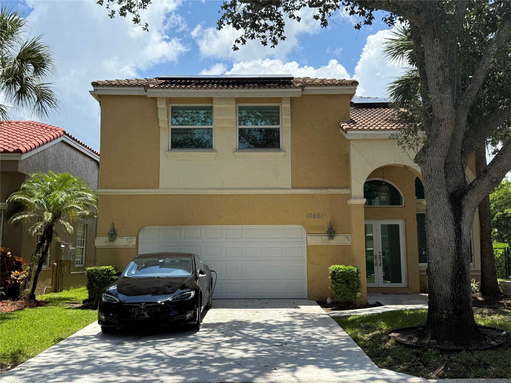 Welcome to this stunning home with soaring 20-foot ceilings that create a grand and open feel from the moment you walk in. 4-bedrooms, 2 full bathrooms are upstairs and a convenient half bath on the main floor. The oversized primary bedroom offers ample space. The newly renovated kitchen boasts sleek quartz countertops with stainless steel appliances. Enjoy peace of mind with hurricane impact windows and doors, as well as energy efficiency from solar panels that can significantly lower your electricity bills. Desirable corner lot, includes a large fenced backyard ideal for relaxing or entertaining. The garage is equipped with electric car charger outlet, making Electrical Vehicle ownership more convenient than ever. Community has a pool.