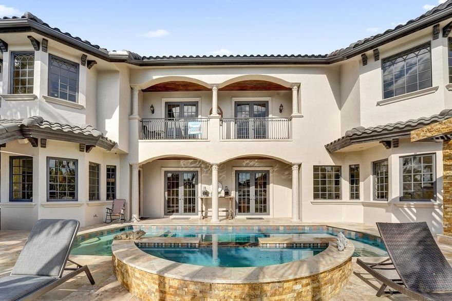 Welcome to this spectacular deep water estate in Lighthouse Point, FL, where luxury meets tranquility on the Alamada waterway. This prestigious residence boasts 6,490 SF of architectural elegance, featuring a grand foyer with stately Cypress doors and a sweeping staircase. The home is perfect for entertaining, with a renovated resort-style pool, spillover spa, and a new summer kitchen overlooking lush landscaping and the canal. The Owner's Suite offers a spa-like bath, his & hers walk-in closets, a private office, and a balcony with canal views. A large VIP suite on the main level provides flexibility for an additional owner's suite. Enjoy 80+/- ft of dockage, featuring new cap, batter pilings, and a jet ski floating dock, just minutes from the ICW. Don't miss this luxurious oasis!