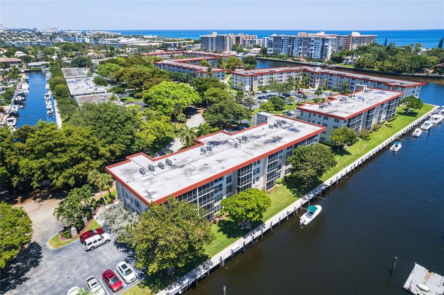 Spacious unfurnished 3BR/2BA 1st-floor corner unit in prime Lighthouse Point location with wide canal views and available boat dockage. This bright, open condo lives like a single-family home and features a split floor plan, impact windows/doors, enclosed patio for extra living space, and new wood-look tile throughout. The open kitchen includes granite counters, white cabinetry, stainless steel appliances, wet bar, and new dishwasher. The luxurious master bath offers a Jacuzzi tub and rain shower. Full-size washer/dryer, newer A/C, and park right at your front door. Set on 17 acres of beautifully maintained grounds, waterfront pool, shuffleboard, clubhouse and with plenty of guest parking. Enjoy waterfront living in this updated, move-in ready home — and enjoy the best of LHP!