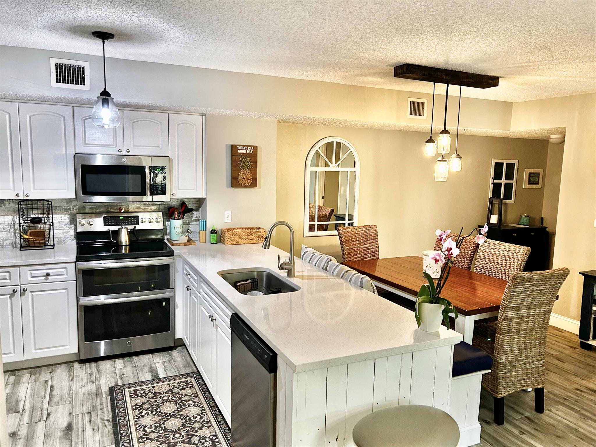 SELLER MOTIVATED! Fully remodeled unit within the resort style community of Lighthouse Cove in coveted Village of Tequesta! Beach cottage inspired 2/2 unit, split floor plan, new porcelain wood plank flooring throughout, new quartz kitchen & bathroom countertops, stainless steel kitchen appliances, unique bench seating with storage in dining area, newer hot water heater (2017) & AC (2019), new lighting fixtures & a completely updated 2nd bathroom. Both bedrooms have ensuite bathrooms with custom walk in closets. Master Bedroom boasts custom shaker molding & shelving. Accordion hurricane shutters & NEW ROOF in 2022. All legally required engineering reports were completed in 2024, resulting in a reduction in HOA dues!! Come live the ultimate Florida lifestyle & enjoy the lavish tropica