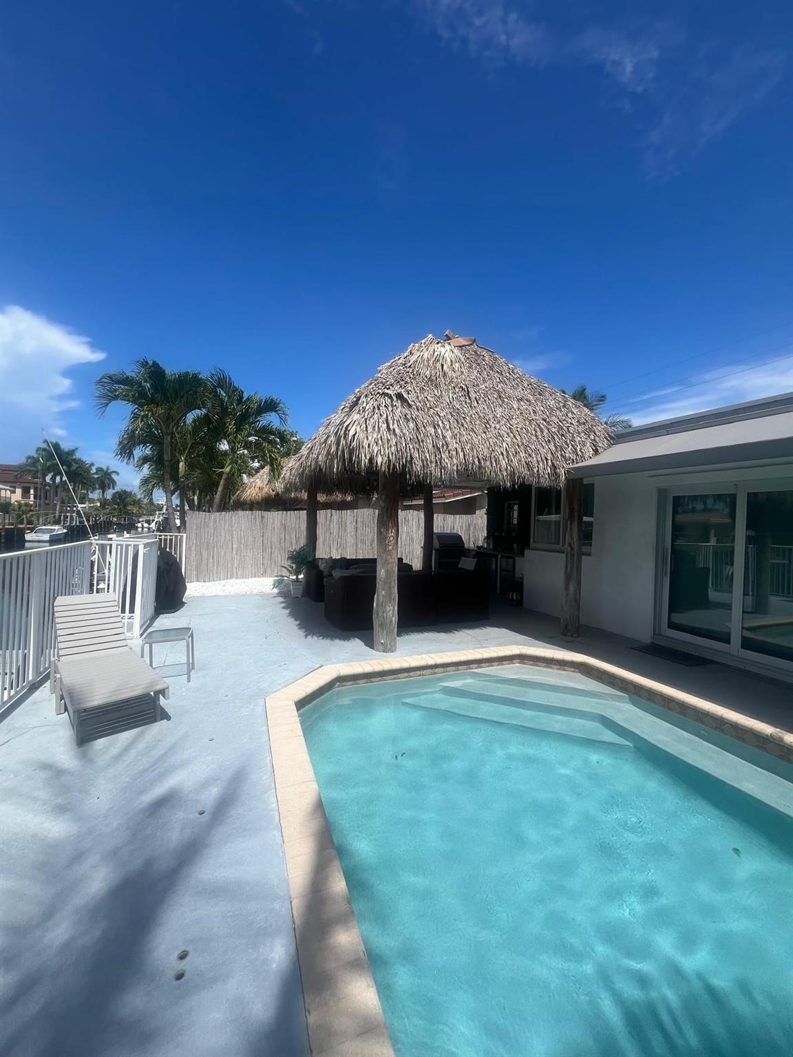 Deep waterfront home with heated pool, hottub and outdoor kitchen. Furnished 3 bedroom/3 bath plus bonus room with sleeper sofa.