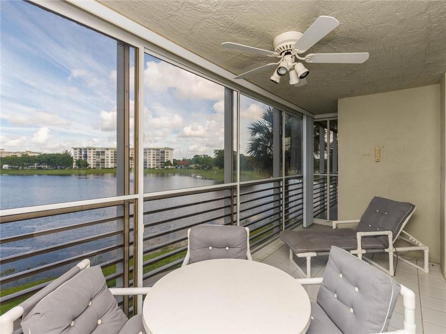 SPACIOUS AND BRIGHT THIS END UNIT WITH LAKE VIEWS IS WONDERFUL! 3 BEDROOMS AND 2 FULL BATHS...FORMAL ENTRY FOYER LEADS TO AN OPEN LIVING AND DINING ROOM...THE UNIT BOASTS ALL HURRICANE IMPACT WINDOWS AND DOORS...FULLY APPLIANCED KITCHEN...LARGE MASTER WITH ENSUITE THAT OFFERS A WALK-IN AND A REACH IN CLOSET, BUILT-IN DRESSING TABLE, AND FULL BATH WITH GLASS FRAME SHOWER DOORS, & FULL LENGTH VANITY FOR STORAGE...2 ADDITIONAL GUEST BEDROOMS, ONE BEING USED AS A FAMILY ROOM/DEN...THE WRAP-AROUND SCREENED IN PORCH IS DIVIDED INTO 2 SECTIONS, ONE SIDE OFFERS PLEXIGLAS SLIDERS AND ACTS AS A THREE SEASON PORCH, CLEAN AND DRY, THE OTHER SIDE IS OPEN TO THE AIR AND LAKE BREEZES...IN UNIT WASHER AND DRYER...ONE ASSIGNED PARKING SPACE + GUEST...AMENITY RICH COMMUNITY WITH HEATED POOL AND CLUBHOUSE