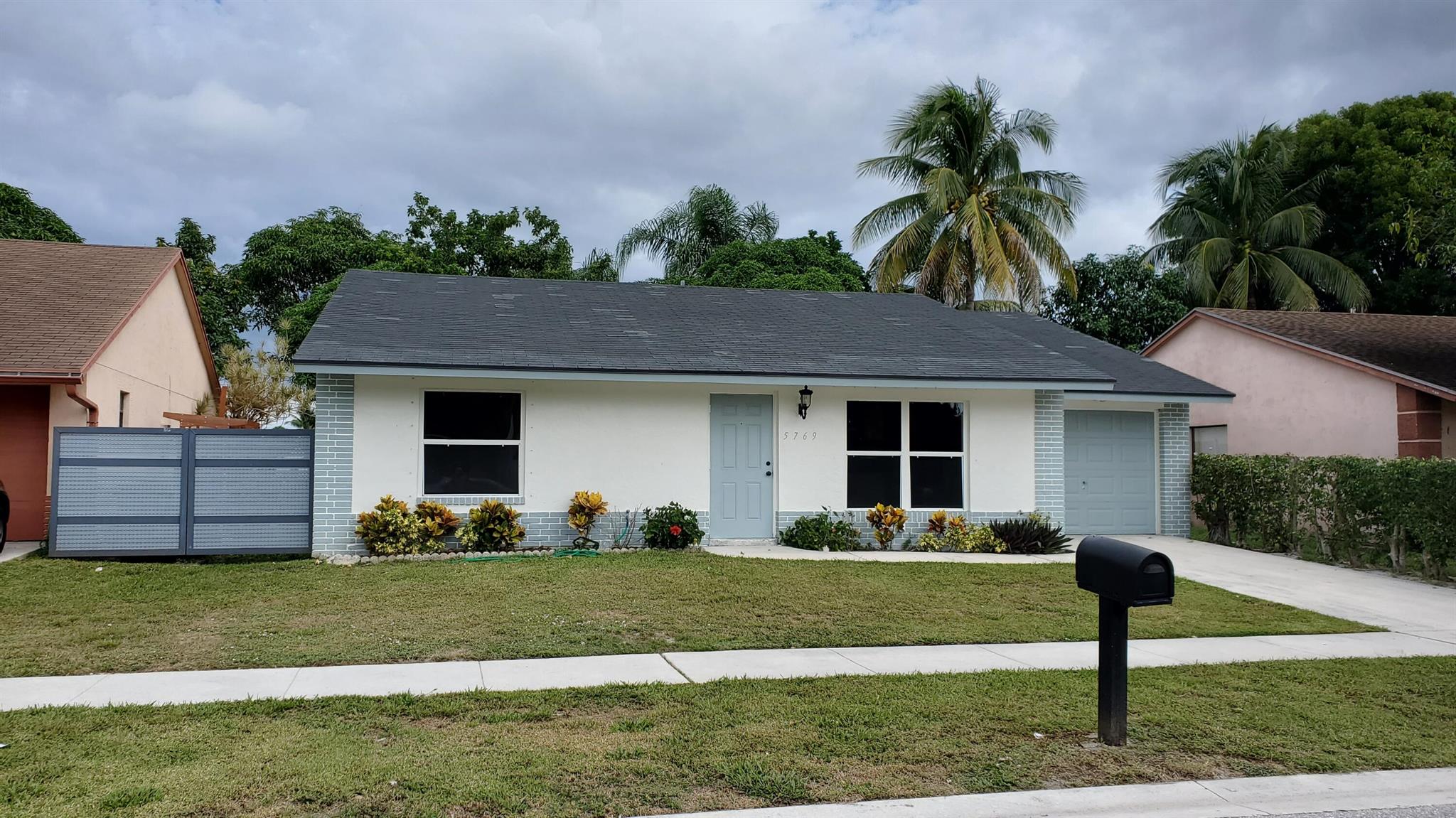 Beautifully upgraded home with a great fenced and private waterfront back yard. Black Stainless appliances, Quartz counters and white Shaker cabinets give the kitchen a clean fresh look. There are two huge pantry cabinets along side the French Door refrigerator. The main bedroom also overlooks the back yard and lake, and has a beautifully updated bathroom and custom closets. The 2nd bath is also nicely updated. There is new tile throughout the house with no carpet! There are upgraded full size washer and dryer, and an oversized one car garage with opener. There's a powered awning for shade in the back yard, and hurricane shutters for all windows. And there's Natural Gas to efficiently power your range, water heater and clothes dryer. This is a great home in a a great location.
