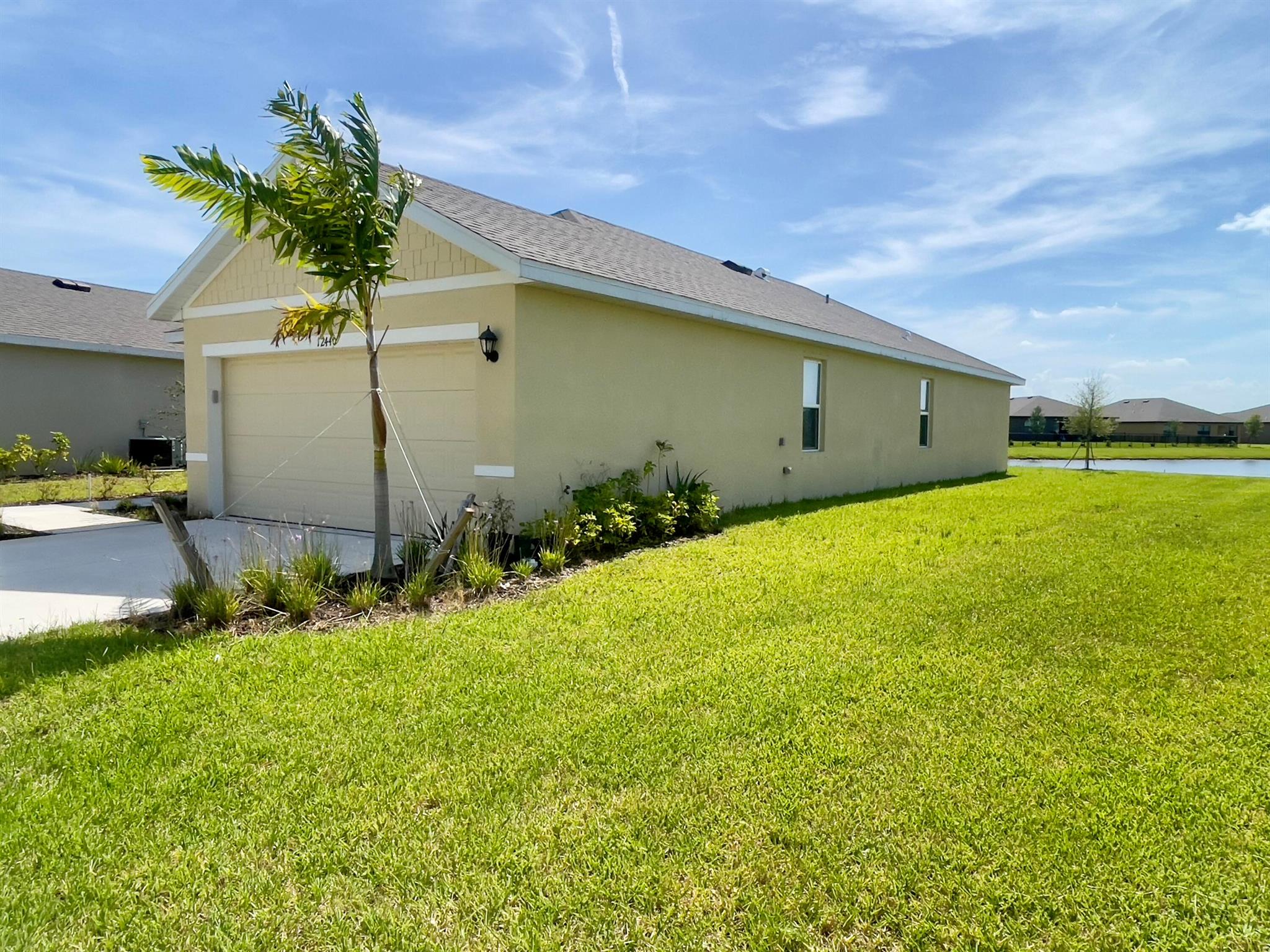 MOVE IN SPECIAL! This 3-bedroom, 2-bathroom, 2-car garage home is located in the Central Park community of Port St. Lucie. Less than 2 years old, it offers over 1,500 sq. ft. of open living space. The kitchen overlooks the family room and leads to a covered patio. The living and dining areas get plenty of natural light.The Primary's suite features a walk-in closet, double sinks, and a large walk-in shower. The home sits on a wider end lot with a peaceful water view from the backyard. It's in a quiet, easy-access neighborhood--just 7 minutes to I-95 and 6 miles to the Florida Turnpike.