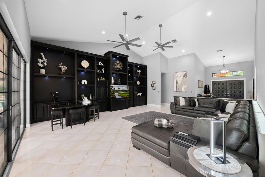 Elegant 3 bed/4.5 bath golf course home at Woodmont Country Club. Large 15,000+ sq ft (1/3 acre) lot on quiet cul-de-sac, fenced yard, privacy hedges, spa, gazebo, large screened lanai overlooking saltwater pool and fairway. Enjoy soaring cathedral ceilings, custom cabinetry, and modern lighting. Large gourmet kitchen includes quartz counters, new SS appliances, chef sink, pull-out pantry shelves,  and under-cabinet lighting.  Features include separate formal/casual dining areas, lavish primary suite w/ a wall of custom cabinets for extra storage, his-&-hers walk-ins, all bathrooms fully renovated, including master bath with soaker tub, and a poolside cabana bath. Extras: 3-car garage, separate laundry room, impact windows (insurance discount), newer roof (8 yrs), whole-house generator.