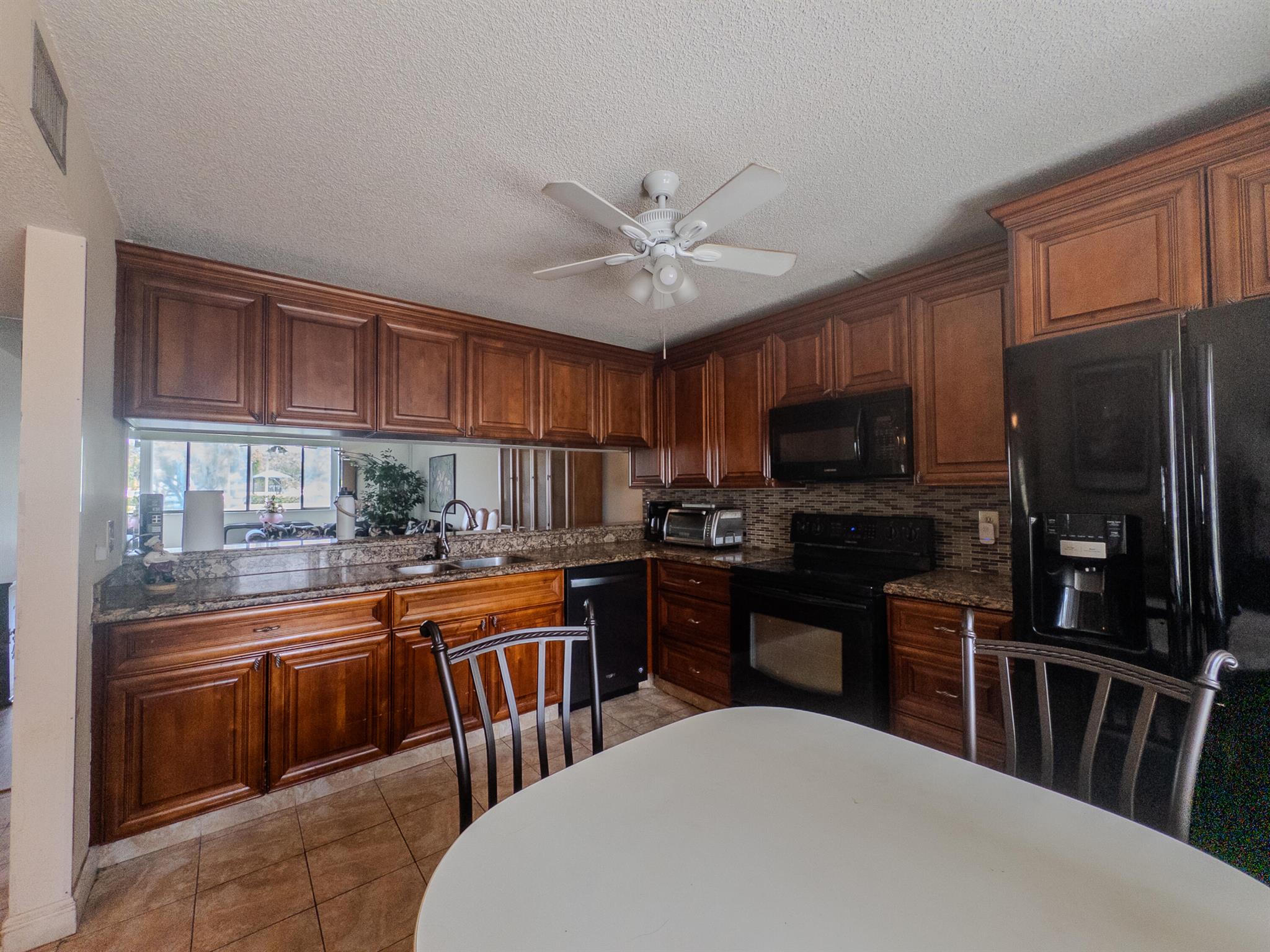 Charming 3-bed, 2-bath corner unit in peaceful North Lauderdale! This spacious 1st-floor condo offers 1,480 sqft of living space, a sunroom with serene lake views, and a master suite with a huge walk-in closet. Washer & dryer included. Seller is willing to include all furniture--just move right in! Built in 1984 and well maintained. HOA includes cable & water. Comes with a covered parking spot valued at $5K. Quiet location, far from main roads. Priced to sell quickly! Don't miss this rare find--schedule your showing today!