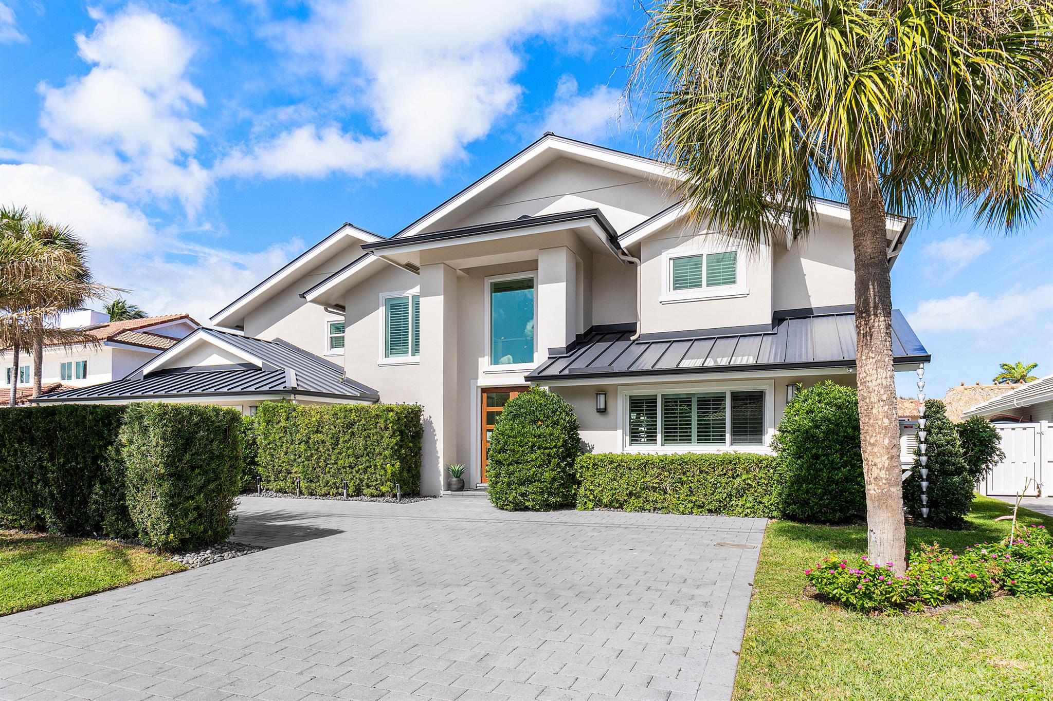 Welcome to your fully remodeled 4 bedroom 4 bathroom waterfront home in the highly sought-after Tropic Isle community. Boasting 90 feet of prime waterfrontage on the widest deep-water canal, this residence is just 5 houses from the Intracoastal with direct ocean access, making it a true boaters paradise. The chef's kitchen features Viking and Sub-Zero appliances, a spacious island, and plenty of room to entertain, complemented by a butler's pantry and newly designed custom temperature controlled wine room. Outside, the resort-style backyard features new turf for easy maintenance and a covered pergola with a fully equipped summer kitchen, saltwater pool, ample lounging space, and serene waterfront views.