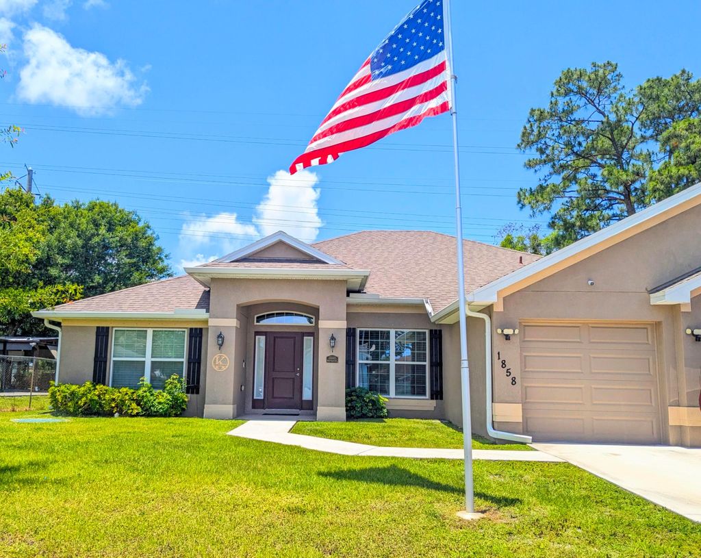 Photo of 1858 SW Mackenzie Street, Port Saint Lucie, FL 34953 (MLS # B26032312)