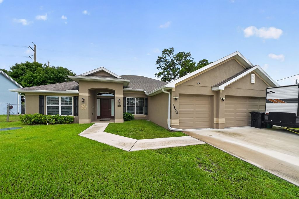 Photo of 1858 SW Mackenzie Street, Port Saint Lucie, FL 34953 (MLS # B26032312)