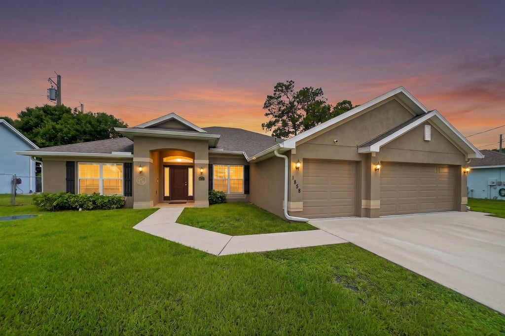 Photo of 1858 SW Mackenzie Street, Port Saint Lucie, FL 34953 (MLS # B26032312)