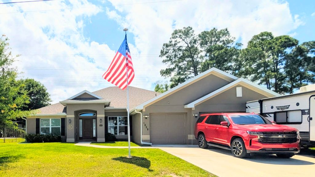 Photo of 1858 SW Mackenzie Street, Port Saint Lucie, FL 34953 (MLS # B26032312)