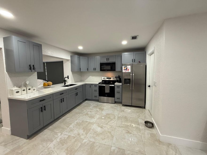 Motivated Seller! Beautifully remodeled 3-bedroom, 2-bath home located on a quiet cul-de-sac with no HOA. This home features porcelain tile flooring, modern LED lighting, ceiling fans with remotes, and a fully updated kitchen with blue cabinetry, quartz countertops, backsplash, and stainless-steel appliances. Enjoy a spacious backyard, enclosed patio, 1-car garage, laundry room with washer and dryer, accordion hurricane shutters, and a new impact-rated front door.