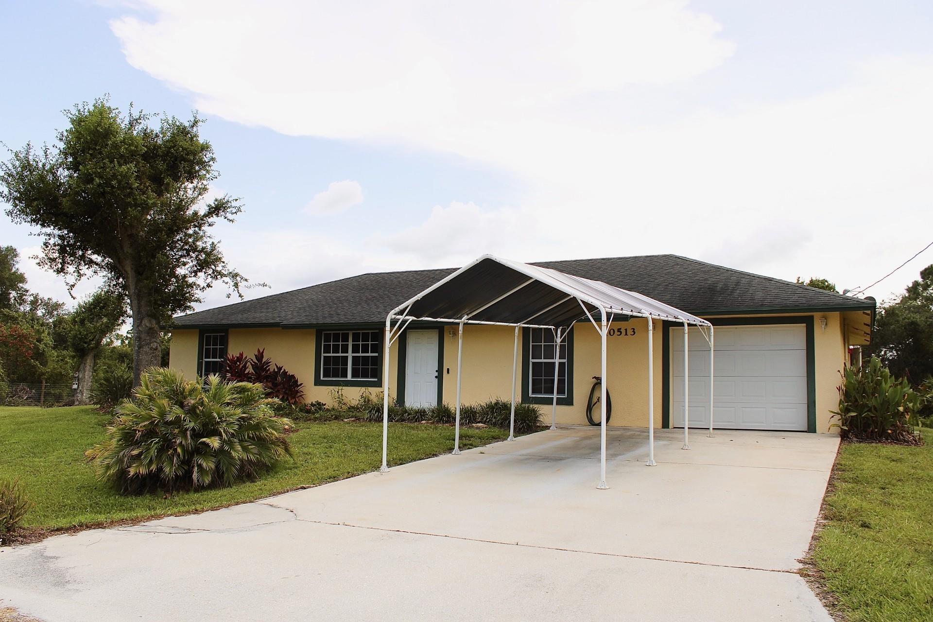 Charming 3-bed, 2-bath split-plan home on a spacious .38-acre lot in Orange Blossom Ranches. Located in a quiet, no-HOA neighborhood in Okeechobee, this property offers peaceful country living with room to grow. The layout ensures privacy and comfort, while the fenced area is ideal for pets. Enjoy the covered back porch and envision a future pool, garden, or entertainment space in the generous backyard. A great option for those seeking flexibility and space.