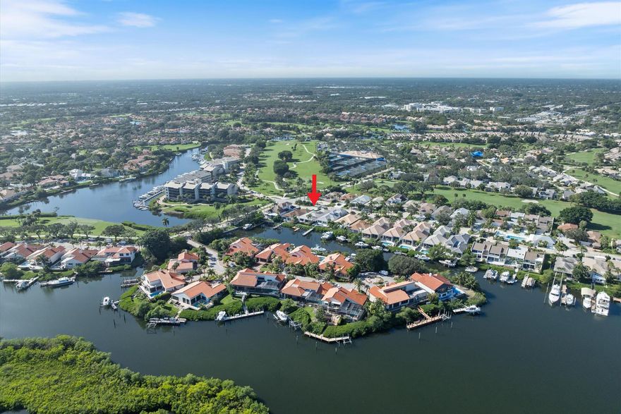 Waterfront dream home reimagined located in the prestigious gated community of Jonathan's Landing, right in the heart of Jupiter. Ocean access & no fixed bridges, this property is perfect for boating enthusiasts, featuring a 16,000-lb boat lift, 2023 seawall w/ an 80' recorded pier easement. Completely remodeled in & out with impact windows, top-of-the-line appliances, stunning quartz countertops, & imported Italian tile throughout. Enjoy a breakfast bar w/ views of the waterway, wet bar with a wine cooler, and a family room equipped w/ an 86'' LG TV and linear fireplace. Additional features include 8' solid wood doors, an oversized primary suite, large 2-car garage w/ an epoxy floor, 2017 roof, Trex patio deck overlooking the serene waterway. Don't miss this exceptional opportunity!