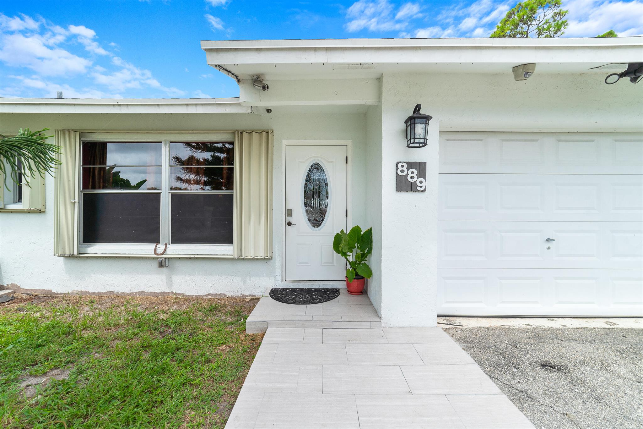 Discover this charming 2-bedroom, 2-bath single-family home in the heart of Palm Beach County with no HOA and sitting on nearly a quarter-acre lot. The home is structurally sound and ready for your personal touch, featuring a 2022 roof, 2024 high-efficiency A/C, concrete block construction, and full accordion shutters for peace of mind. Cozy up by the working fireplace, with a chimney fully redone in 2022 for added value and safety. Inside, you'll also find a spacious den that can easily be converted into a third bedroom. Step outside to enjoy your above-ground pool with newer equipment, or relax in the screened-in patio, adding approximately 500 sq. ft. of versatile living space.