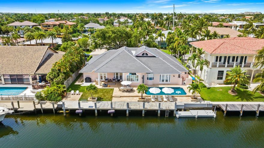 Boater’s paradise! This stunning one-story waterfront home offers 4 beds, 4.5 baths, and 3,300 sq ft of luxury living. A grand foyer, vaulted ceilings and an open-concept layout flow seamlessly to the outdoors. Boasting 100' feet of ocean-access frontage NEW concrete dock & sea-wall, 30' floating dock, and upgraded power—perfect for your yacht. Entertain by the resort-style Diamond Brite pool with travertine marble deck, wood paneled ceiling patio. The chef’s kitchen dazzles with Bosch & Sub-Zero appliances, island with bar seating, and sleek design. The spacious primary suite boasts custom built-ins, jetted tub, dual vanities, and a newly tiled cabana bath. Plus: 3-car garage and new tile roof (2024). Coastal luxury at its finest—bring your boat and live the dream!