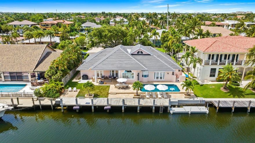 Boater’s paradise! This stunning one-story waterfront home offers 4 beds, 4.5 baths, and 3,300 sq ft of luxury living. A grand foyer, vaulted ceilings and an open-concept layout flow seamlessly to the outdoors. Boasting 100' feet of ocean-access frontage NEW concrete dock & sea-wall, 30' floating dock, and upgraded power—perfect for your yacht. Entertain by the resort-style Diamond Brite pool with travertine marble deck, wood paneled ceiling patio. The chef’s kitchen dazzles with Bosch & Sub-Zero appliances, island with bar seating, and sleek design. The spacious primary suite boasts custom built-ins, jetted tub, dual vanities, and a newly tiled cabana bath. Plus: 3-car garage and new tile roof (2024). Coastal luxury at its finest—bring your boat and live the dream!