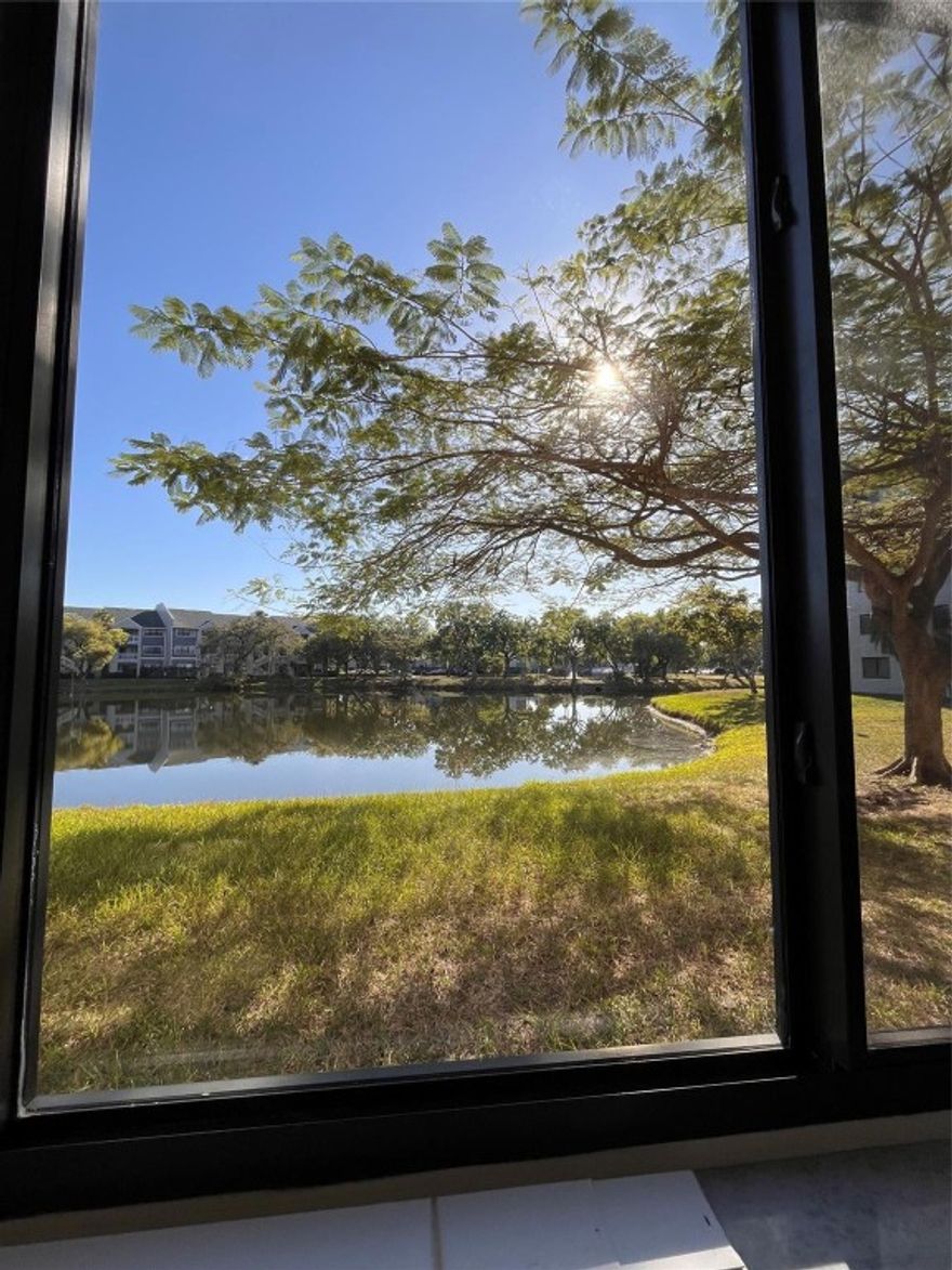 Large, oversized 2-bedroom / 2-bathroom unit featuring spacious walk-in closets, ample storage, and a dedicated laundry room. Fully tiled throughout, with a bonus office space or children’s play area. Impact windows in this first floor unit with a lake view, located in a well-maintained gated community.Amenities include:  2 pools, tennis court, pool table, and multipurpose room. Trash, pest control, basic cable, and internet are included.