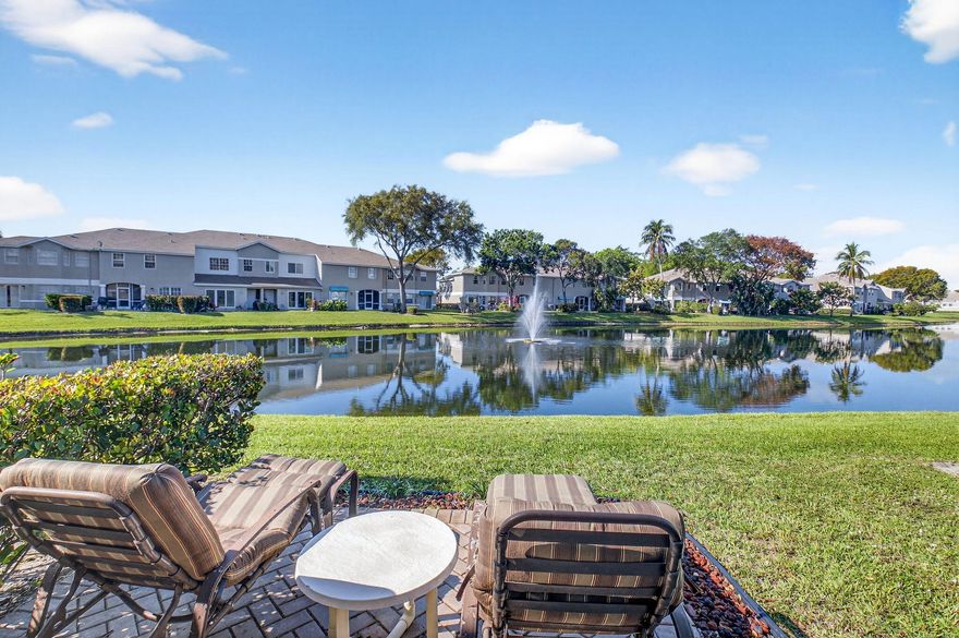 Welcome to this beautifully maintained , professionally landscaped and rarely available two-story townhome in the desirable Boca Gardens community! Offering 1,916 sq. ft. under air, this spacious 3-bedroom, 2.5-bath residence is ideally positioned at the end of a quiet street and showcases one of the best lake views in the neighborhood with breathtaking sunset vistas. The thoughtfully designed floor plan features a primary suite on the ground floor with generous closet space, while two additional oversized bedrooms and a full bath are located upstairs. The home has been impeccably cared for and thoughtfully upgraded throughout, including a NEW ROOF (2026), fresh interior paint, a brand-new refrigerator (2026), and an updated kitchen with stainless steel appliances. Elegant ceramic tile  floors on main level, complemented by high-quality patterned carpeting on the stairs and second floor. The staircase banister has been replaced, adding a refined touch. The fully permitted garage conversion creates an exceptional home theater or flexible living space.    Step outside to a high screened patio overlooking the lake — the perfect place to relax and enjoy spectacular sunsets. A custom lakefront patio and beautifully designed walkway enhance both the outdoor living experience and curb appeal. Additional features include UV lighting in the A/C system for improved air quality.    Conveniently located near one of the community pools, this home offers the ideal combination of privacy, space, and lifestyle. Available furnished or unfurnished, this move-in-ready residence truly has it all.    Don't miss this opportunity to own a special lakefront home in one of Boca Raton's most sought-after communities. Lakefront home. Living in Boca Gardens means resort-style amenities right at your fingertips: 3 community pools, tennis and pickleball courts, a clubhouse, playgrounds, and walking paths. All this with low HOA fees that include cable,, roof maintenance and REPLACEMENT, and exterior care. Conveniently located near A-rated schools, shopping, restaurants, and major highways, this home offers both comfort and lifestyle. Don't miss this opportunity to own one of the most desirable models in Boca Raton's Boca Gardens!