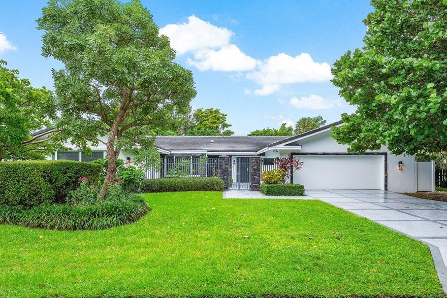 Experience the epitome of coastal elegance in this renovated, single-story estate located in the prestigious Estates section of Spanish River Land. This exquisite 5-bedroom, 5-bathroom pool home, with an additional den, boasts a thoughtfully designed 3-way split bedroom plan, ensuring privacy and comfort for all. The open and airy layout, enhanced by contemporary white and gray finishes, seamlessly connects the indoor and outdoor living spaces, perfect for entertaining.Key features of this luxurious home include all HURRICANE IMPACT windows and doors, a brand-new main and flat roof completed in 2024, freshly painted exterior, and a HURRICANE-RATED garage door. The oversized kitchen, equipped with top-of-the-line KitchenAid stainless steel appliances, offers stunning views of the pool