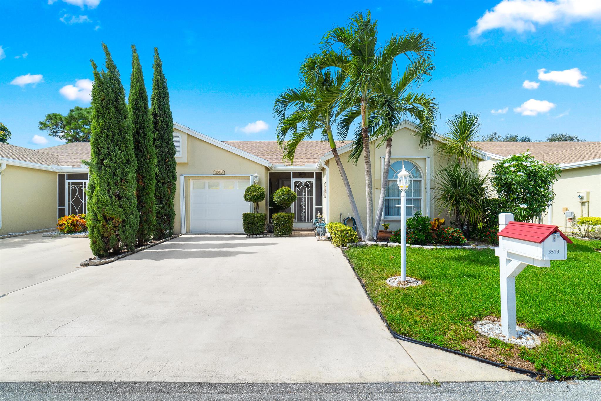 Welcome home! This sunny 1,371 sq ft villa offers 3 bedrooms and 2 baths with a 1-car garage, all wrapped in a light and open layout. Step inside to vaulted ceilings, a kitchen that invites gathering (complete with stainless steel appliances), and plenty of room to move. The living spaces feature tile flooring while the bedrooms stay cozy with carpet underfoot. One of my favorite spots? The screened-in patio, which overlooks a peaceful water view and makes morning coffee or evening relaxing extra special.As part of The Villages of Woodlakes (55+ community), you'll enjoy access to neighborhood lakes, a clubhouse & pool, plus easy access to shopping, beaches, and PBI Airport. This home feels personal, comfortable, and ready for someone to bring their own style.  Schedule a showing!