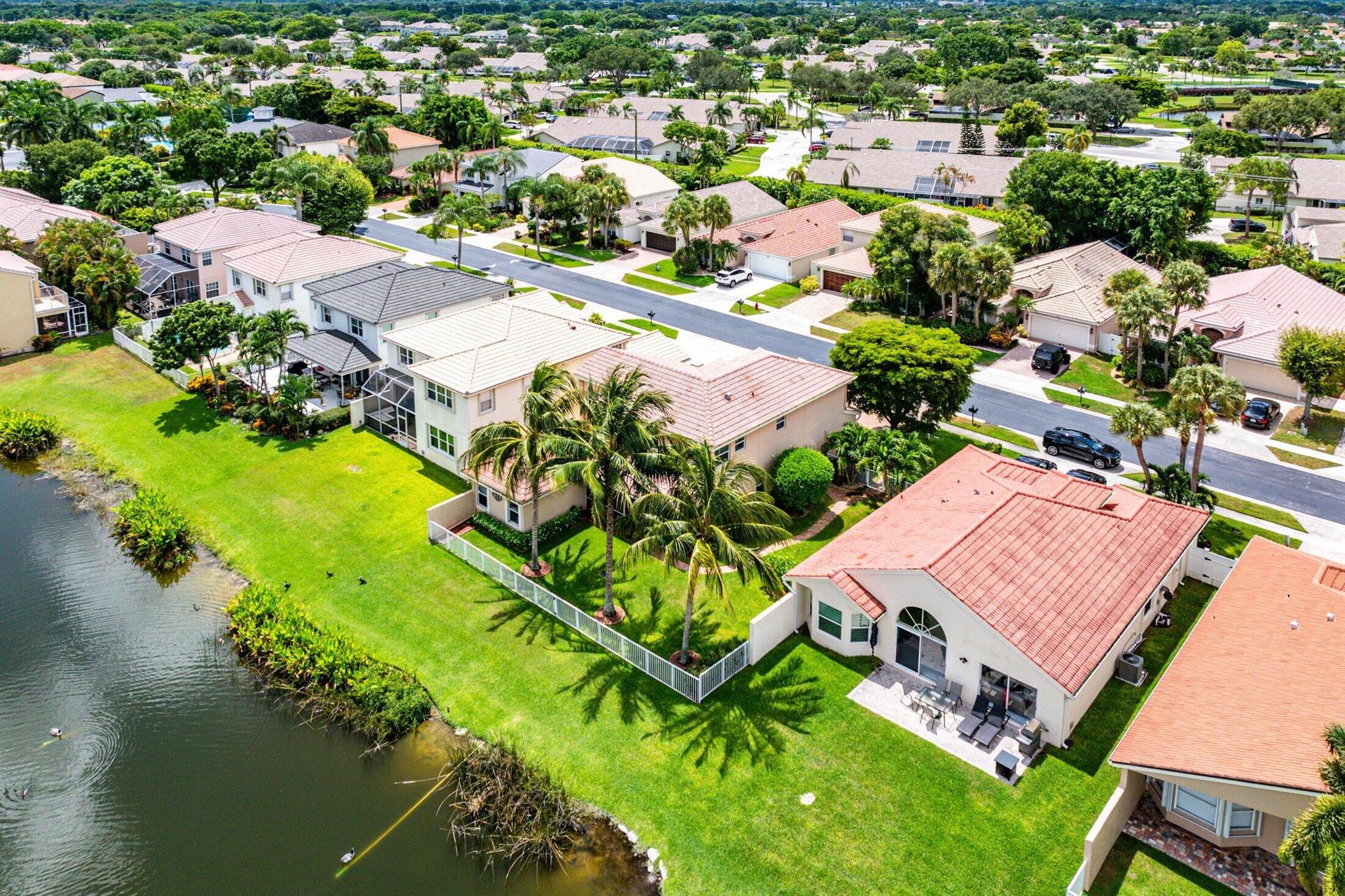 Set on the widest lakefront lot in the community, this exceptional 4-bedroom, 3.5-bath home with an open loft offers unmatched outdoor space, ideal for privacy, play or entertainment. The expansive fenced side yard is a standout feature rarely found in the neighborhood--perfect for families, pets, or future enhancements--all with serene lake views as your backdrop. Inside, the home is equally impressive. A ground-floor primary suite--added in 2014--complements the original upstairs suite, creating a flexible layout perfect for multi-generational living or hosting guests. The open loft easily converts to a 5th bedroom, office, or media room. Notable upgrades include Complete impact windows & doors, Whole-house generator with 500-gallon underground propane tank, Gas Range, Solid wood cabinet