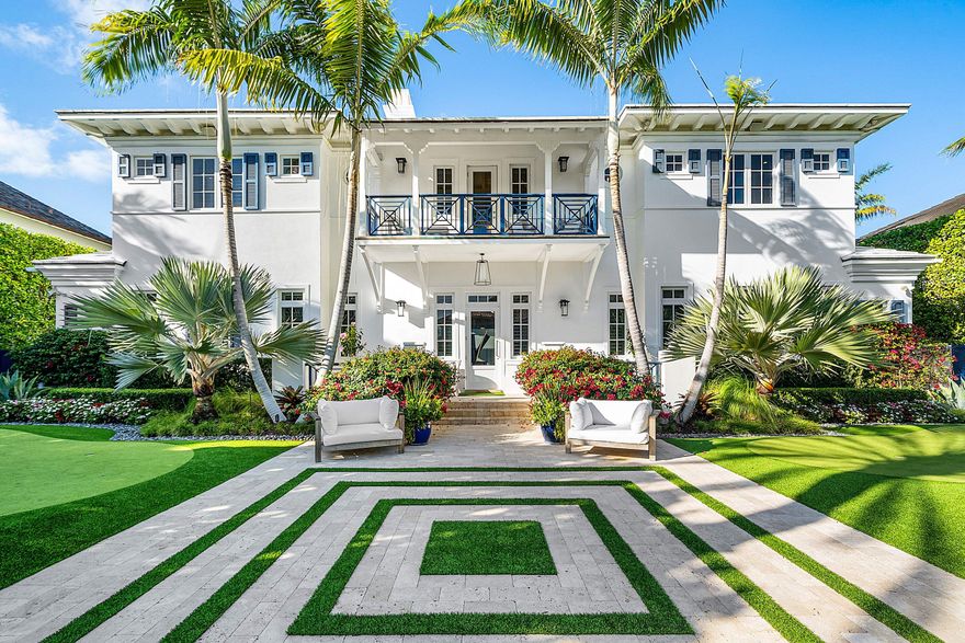 Just one block from the Atlantic Ocean and a few blocks from Atlantic Avenue, this gated Bermuda Estate is set within one of Delray Beach's most coveted beachside enclaves. Privately positioned at the end of two quiet cul-de-sacs, the property offers rare dual street frontage with private ingress and egress, a gracious courtyard entry, and a separate rear motor court with a three-car garage. Designed by renowned Affinity Architects, the residence spans 7,716 total square feet and offers five bedrooms, a beautifully designed office featuring a custom built-in motorized desks and French doors that open to the veranda overlooking the resort-style pool. A private elevator provides convenient access to the upper level. Expansive covered loggias and a wraparound veranda create seamless indoor-outdoor living, complemented by soaring beamed ceilings and walls of floor-to-ceiling pocketing glass. The resort-style grounds feature a newly completed pool and spa with a professional stationary swim system, fire feature, putting green, and generous outdoor entertaining areas. The redesigned chef's kitchen showcases Neolith Estatuario surfaces, professional-grade appliances, and two fully equipped butler's kitchens with newly renovated bar and wine storage for effortless hosting. Additional highlights include a dedicated screening room with 7.1 surround sound, a fully independent guest suite with private entrance and security system, custom architectural loggia detailing, and meticulously landscaped grounds with mature trees and premium performance turf. The overall level of exceptional architectural details make this a rare opportunity for refined, walkable beachside living in the heart of Delray Beach.