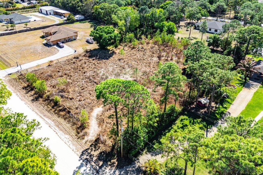Not many cleared 1.66 acres left to build on out here in Loxahatchee!  Permit and plans are already completed for a beautiful modern home expanding over 3,700sqft of living space!  Ask for specific details. If you are thinking of buying and holding onto land for an investment or if you're considering building your dream home, now is the time to do it before it's to late!  This is the real peace and quiet everyone in Lox is looking for.  No neighbors across the street allows for a real rural setting while still being close to any and all major amenities and attractions. No hoa so bring all your animals, toys and hobbies to your own property!  Come and experience true Lox Life Living!