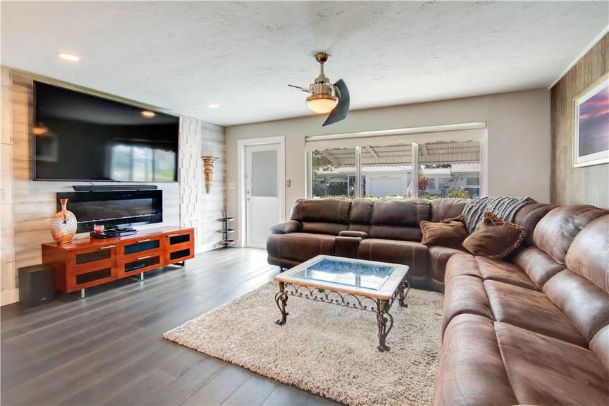 Huge price reduction!!!  Owners extremely motivated. Beautifully updated large 2/1 home with 1 car garage in 55+ Leisureville. Newer Stainless Steel Appliances in the gorgeous kitchen with large island. Wood floors and designer upgrades throughout.  Impact windows and doors. Huge living area. This house is steps to the north pool and clubhouse, as well as the free to resident's golf course. This active senior living community has so much to offer including a fitness center and courtesy bus for residents to local markets, banking & shopping. Pet friendly! HOA covers lawn care, pressure cleaning roof every 2 years & pressure cleaning & painting house every 5 years.  This is a must see! Bring all offers!