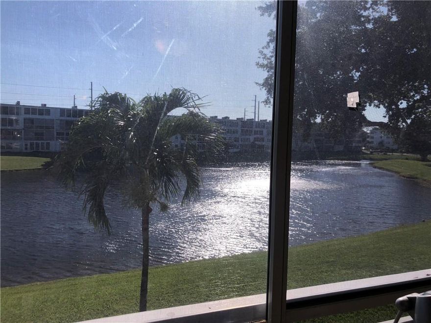 JUST REDUCED!! GORGEOUS WATER VIEWS!! Beautiful completely furnished turn-key condo located in the sought-after 55+ gated community of Century Village. This unit is a one bedroom/ one bath with no carpet found throughout the condo. Open kitchen layout with florida room overlooking the water. Shutters included