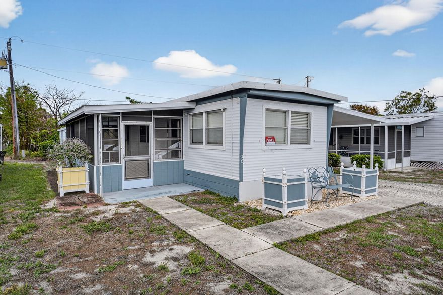 Coastal Living Without the Price Tag! Step into your slice of paradise in this vibrant 55+ Hobe Sound community! Just minutes from pristine beaches, this updated mobile home offers the ultimate Florida lifestyle with NO LOT RENT. For just $250/month, your HOA covers cable, high-speed internet, lawn care, and trash, plus access to the sparkling community pool and clubhouse. Boasting 2021 improvements, central AC, a spacious two-car carport, and a serene covered lanai, this move-in-ready gem includes all appliances and a private storage shed. Quiet, convenient, and incredibly affordable. Cash sale only—grab your flip-flops and move right in!