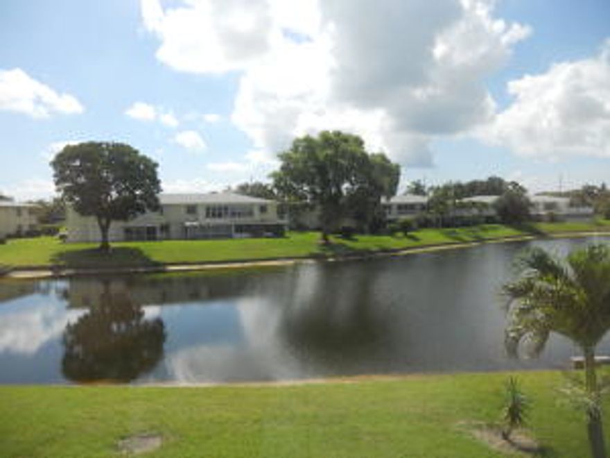WHAT A VIEW! LIVING ROOM PICTURE WINDOW LOOKS OUT ON LAKE WITH ILLUMINATED FOUNTAIN THAT GLOWS IN THE DARK. ENCLOSED BALCONY PROVIDES GREAT VIEW. KITCHEN HAS EXPANDED CABINETS, NEW DISH WASHER. ALL ROOMS HAVE HI-HAT CEILING LIGHTING. MASTER BEDROOM HAS 2ND VANITY (HIS AND HERS), CEILING FAN IN DRESSING AREA. THE ORIGINAL OWNER HAS TAKEN GREAT CARE WITH FURNITURE AND APPLIANCES. IT IS NOW TIME FOR NEW OWNER TO UPDATE AT THIS GREAT LOCATION. {All dimensions are approximate) 1X $2,000. CAPITAL CONTRIBUTION AT TIME OF CLOSING. ALL SERIOUS OFFERS WILL BE CONSIDERED!!  THE PINES OF DELRAY NORTH IS A FRIENDLY GATED COMMUNITY WITH MANY AMENITIES; CLOSE TO THE BEACH AND TRENDY ATLANTIC AVENUE WITH ITS RESTAURANTS AND BOUTIQUES.  (Closing to take place end of AUGUST or thereafter)