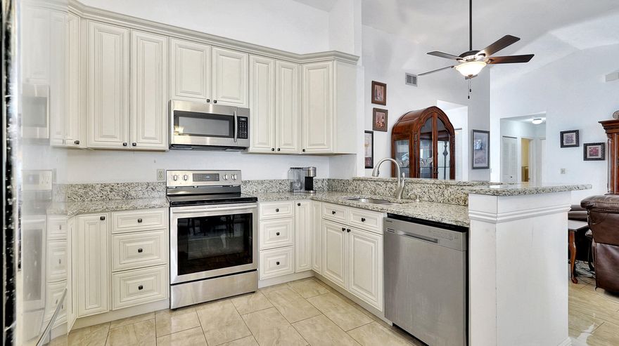 Rarely available updated 2 bed 2 bath home in the coveted Falcon's Lea Community! With a converted screened patio turned dining room, this home boasts extra space and efficiency. The neutral 42'' custom wood cabinetry and 2-year new hi-end appliances make the kitchen a chef's dream. Soaring vaulted ceilings in the great room and primary bedroom add to the sense of spaciousness. And with new porcelain tile floors throughout, cleaning is a breeze. The generously sized bedrooms all feature walk-in closets and the updated bathrooms include a double vanity in the primary. Plus, enjoy the convenience of a LARGE 2-car garage and the beauty of producing avocado and mango trees in the backyard. And don't forget about the community pool directly across the street! Close to all shopping!