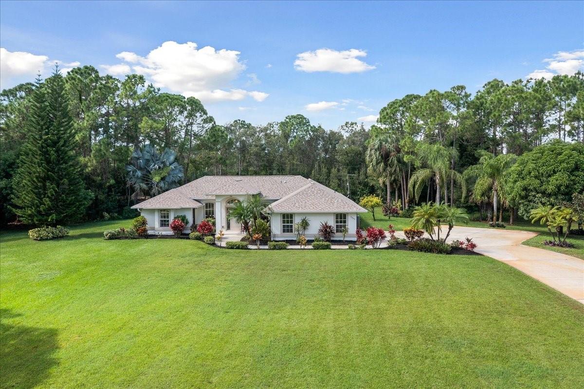 Welcome to your completely refreshed custom retreat in Vero Lake Estates!  Sitting on 1.12 sprawling acres, this 3-bedroom, 2-full bathroom/2-half bathroom custom-built home offers 2,340 sq ft of refined living. Experience true peace of mind with a brand-new roof and fresh paint (interior and exterior) in 2025.  The outdoor oasis features a private, screened-in pool and lanai, freshly resurfaced in 2019, perfect for year-round enjoyment. Inside, find modern convenience with stainless steel appliances and a unique bedroom suite with a separate, private entrance—ideal for a home business, office, or client meetings. The living room opens to an additional screened porch area, affectionately dubbed "heaven" by the current owner. Well-maintained and move-in ready!Additional parking for RV/boat.