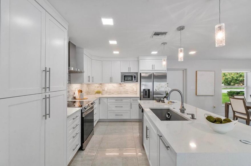 In one of Lighthouse Point's most sought-after residential pockets, just moments from Frank McDonough Park, the Lighthouse Point Tennis Center, local marinas, and the Intracoastal. 

Every major component has been updated: roof, AC, ductwork, sewer lines, PVC plumbing, electrical, impact windows, fencing, lighting, fireplace, bar, and landscaping. It's true turnkey living.

Inside, 3 x 3 porcelain tile runs throughout, complemented by a 16-speaker sound system. The kitchen is centered around a quartz island with matching quartz vanities in the baths. Motorized shades and TVs in every room create a seamless, move-in-ready experience. The primary suite is spacious and includes its own dedicated laundry room. Outdoors, a newly paved circular driveway adds presence. The backyard features porcelain pavers, a saltwater pool, and a summer kitchen with wet bar. A separate 200 SF pool house suite with full cabana bath functions perfectly as a fourth bedroom, office, or guest quarters.

Oversized two-car garage with added storage. Low pool and lawn maintenance.

The information published and provided including but not limited to prices, measurements, square footages, lot sizes, features, finishes, and calculations are subject to errors, omissions or changes without notice. All such information should be independently verified. All parties should perform their own due diligence to verify all information.