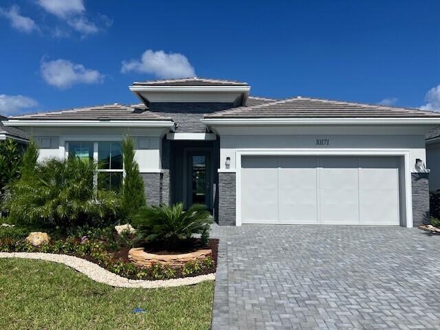 Step into the elegance of the Maya Contemporary a beautifully designed home that offers modern sophistication and everyday comfort. You'll be captivated by the lush, professionally landscaped yard, creating a serene and private outdoor setting complete with a sparkling pool and spacious covered lanai. Inside, the open-concept floor plan is enhanced by sleek porcelain tile flooring throughout, giving the home a seamless, elevated look. The designer kitchen features two-tone cabinetry, upgraded stainless steel appliances, a striking backsplash. The primary suite is a true retreat, showcasing a spacious layout, walk in closet, luxurious finishes, and a spa-inspired bathroom with dual vanities and an oversized walk-in shower.