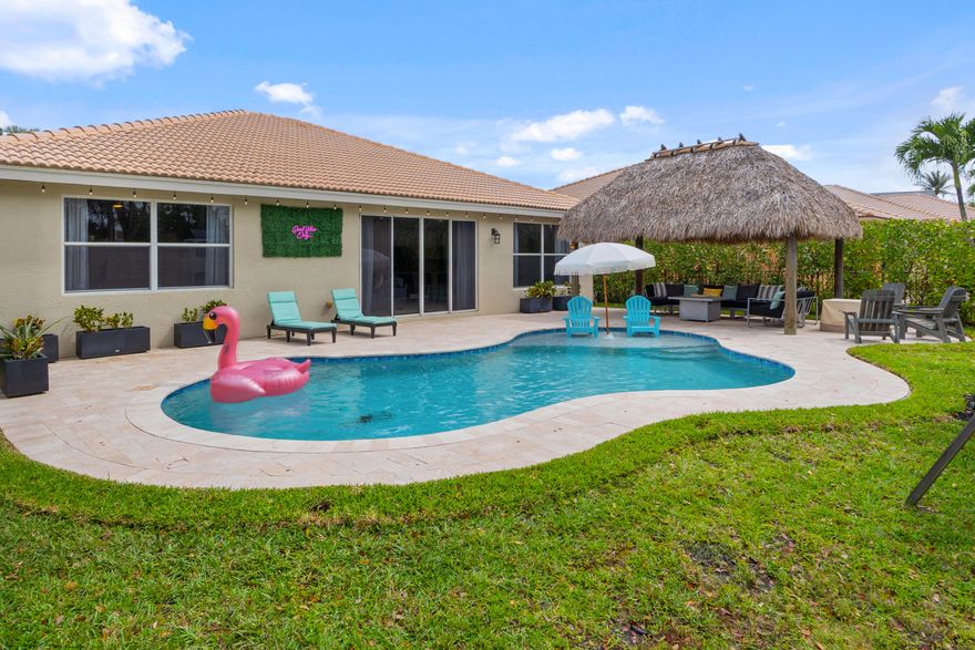 Welcome to your dream home! This well-maintained and beautifully updated 3-bedroom, 2-bath single-family POOL home in Bella Terra, one of Royal Palm Beach's most sought-after gated communities -- is sure to impress. Ideally located just off State Road 7 and Southern Boulevard and minutes from South Florida's Turnpike, this home offers exceptional convenience while being close to shopping, dining,  and Wellington's renowned equestrian area.  Designed with both comfort and privacy in mind, the spacious split floor plan features a private primary suite on one side of the home and two additional bedrooms and a full bath on the other. Inside, you'll find 24-inch ceramic tile throughout the main living areas, LVP flooring in the bedrooms, and a beautifully renovated kitchen and primary bathroom (2018). The kitchen showcases premium soft-close cabinetry, quartz countertops, and overlooks the dining area and great room - perfect for everyday living and entertaining.  The primary suite offers two large walk-in closets and a spacious en-suite bath. Additional updates include a 2019 HVAC, 2018 water heater, a mini-split A/C in the garage (2025), Tesla charger (2025) and exterior security cameras (convey with house), and a nearly new Samsung washer and dryer (1 year old).  Step outside to your private backyard tropical oasis. The custom freeform saltwater pool and travertine deck (2020) create a true resort-style setting, complemented by a fully fenced yard and lush clusia hedges, for added privacy. The tiki hut - with electric, TV, a fan, and lighting - is the perfect space to relax or entertain year-round.  The exterior was painted in 2022, and the roof has been well maintained and recently pressure cleaned. Bella Terra offers a low HOA of just $223 per month and resort-style amenities including a clubhouse, pool, fitness center, tennis and basketball courts, and playground. Located near A-rated schools, this move-in ready home truly has it all. Schedule your showing today!