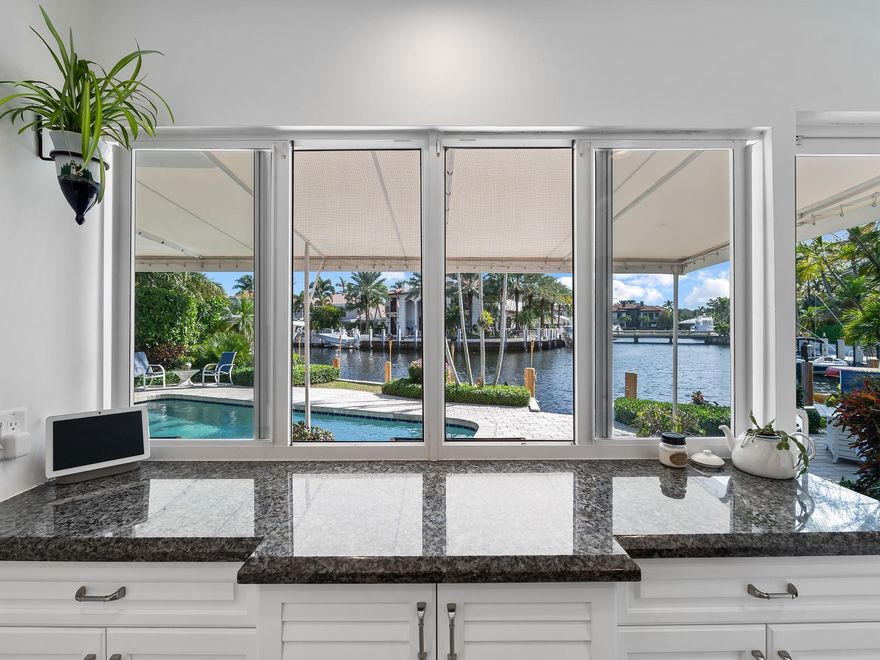 What lovely long water views and what a pleasure it will be for you living in this delightful, picturesque home.  The longtime owners of this home have recently totally remodeled the first floor of their home. This 5-bedroom 3.5 bath home is currently using one of the 2 downstairs bedrooms to accommodate their pool table. A large primary bedroom and two secondary bedrooms are on the second floor as well as a loft area, additional storage and a private deck are off the waterside off the large bedroom.
The southeast exposure, lushly landscaped private backyard and the well positioned pool make outdoor living extremely enjoyable.