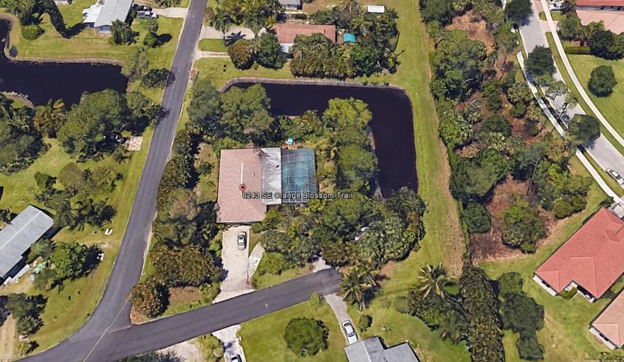 One of a kind property -- Loads of potential in this 3 bedroom, 3 1/2 bath pool home in Poinciana Gardens.  Unique parcel situated on a spacious corner lot surrounded by lush tropical gardens and deeded retention easement on two sides (maintained by Martin County) and dead-end road on one side.  Two bedrooms have private bathrooms.  Cabana bath at pool.  This home has a newer kitchen in 2007 and newer baths in 2005 and 2017.  Roof 2011.  Septic and Drainfield 2010.  No HOA!